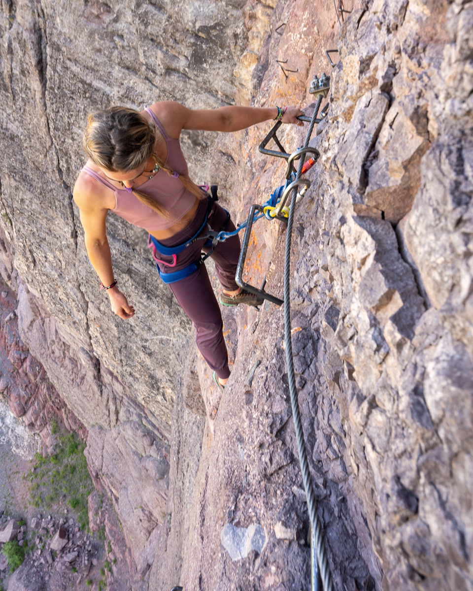 Soul Fire Apparel Co - Chalkras - climbing on rock wall, wearing harness - Dark Purple