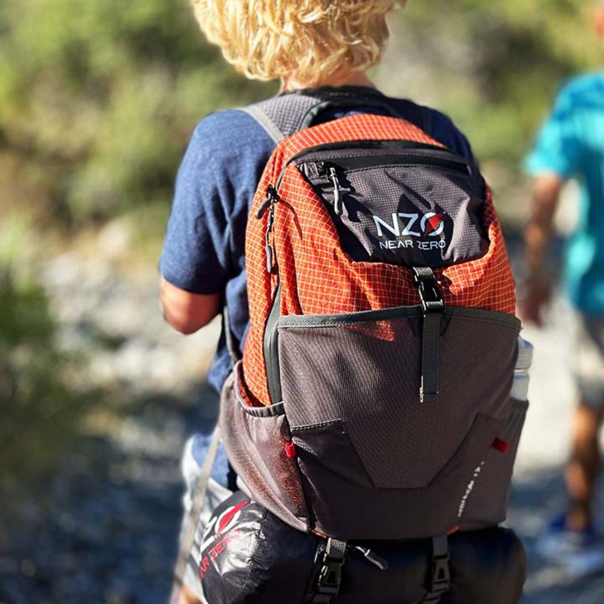 Near Zero Outdoor Gear - Little Dean - 20L Hiking Backpack - Young person hiking with backpack