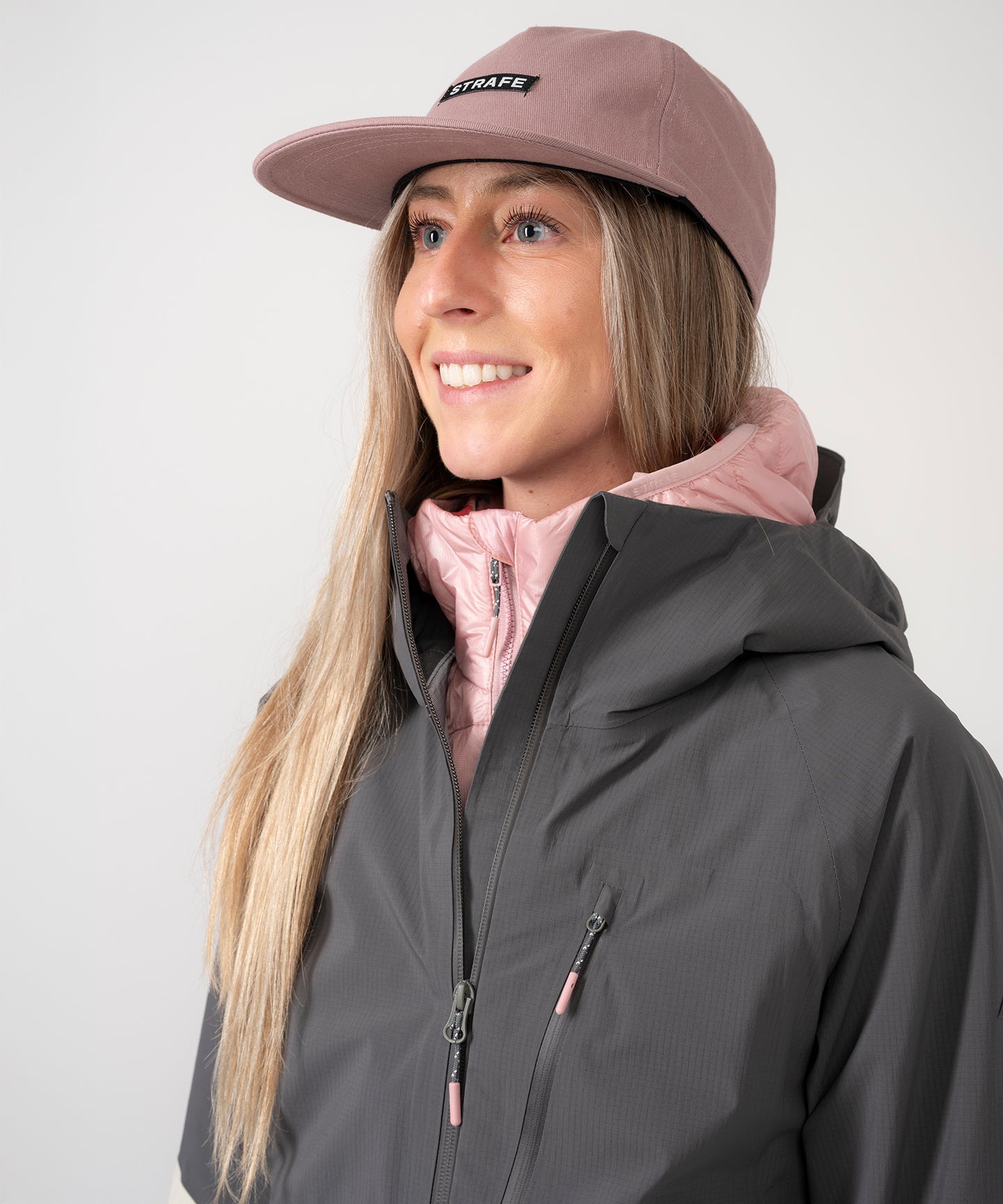 Strafe Outerwear - Meadow 3L Shell Jacket - Woman wearing jacket, front left side, upper torso detail - Light Khaki