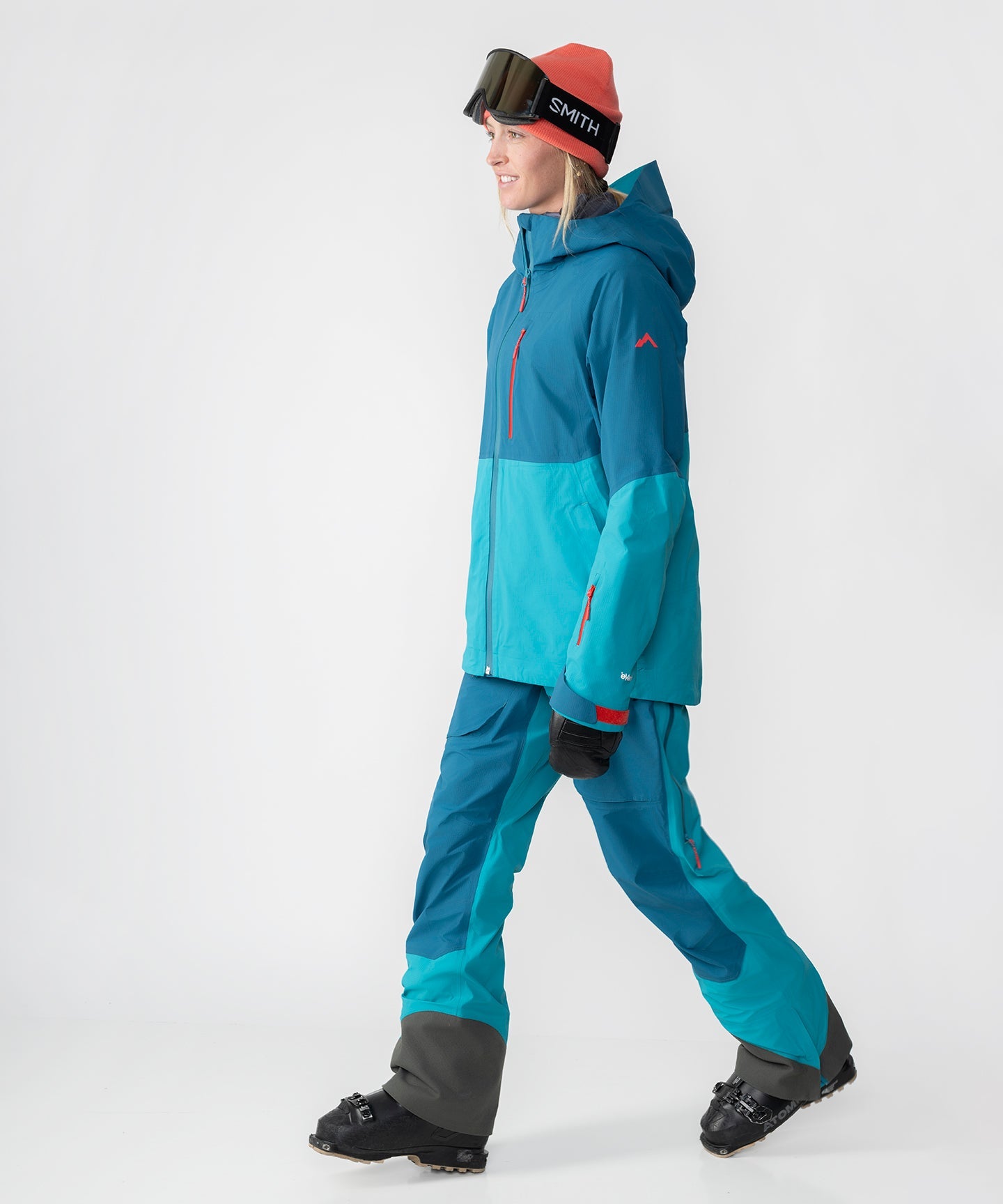 Strafe Outerwear - Meadow 3L Shell Jacket - Woman wearing jacket, walking, left side - Dark Teal