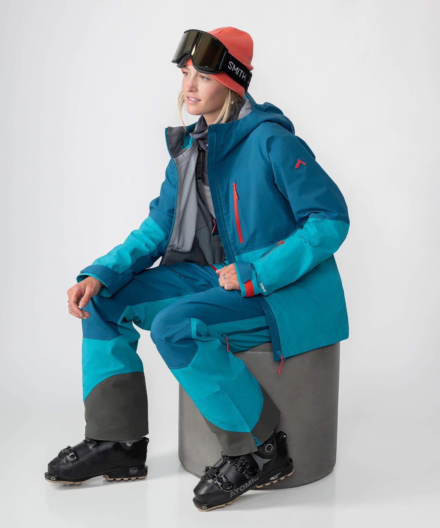 Strafe Outerwear - Meadow 3L Shell Jacket - Woman wearing jacket, sitting, left side - Dark Teal