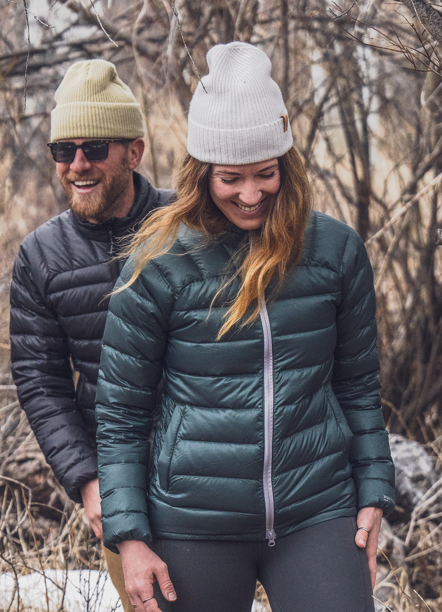 Strafe Outerwear - Palisade Down Insulator Jacket - Woman walking with man, wearing puffy jackets - Deep Forest