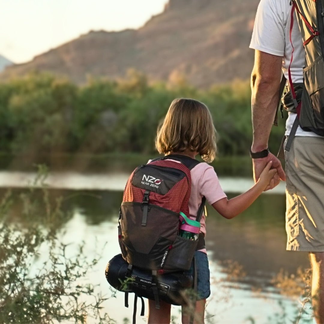 Near Zero Outdoor Gear - Little Dean - 20L Hiking Backpack - Young person wearing backpack near a lake