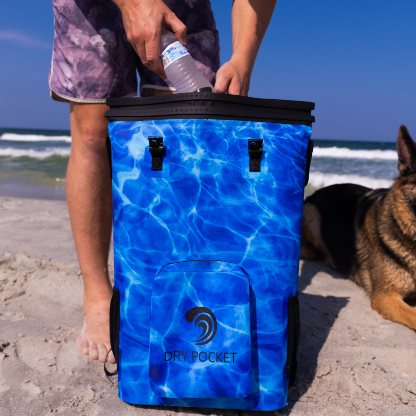 Dry Pocket - Waterproof Floating Cooler Backpack Dry Bag - Aqua Blue - Front with model loading a waterbottle into bag