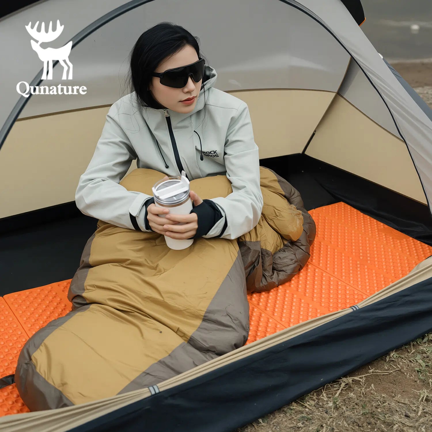 Qunature Global - Ultralight Folding Sleeping Pad Waterproof R-Value 1.8 for Camping & Hiking - Woman in sleeping bag on sleeping pad, inside a tent