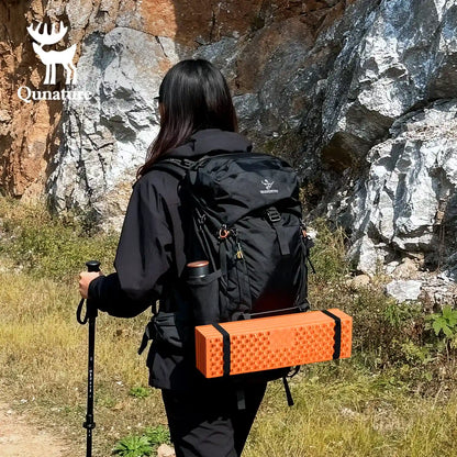 Qunature Global - Ultralight Folding Sleeping Pad Waterproof R-Value 1.8 for Camping & Hiking - Woman hiking with sleeping pad strapped to backpack