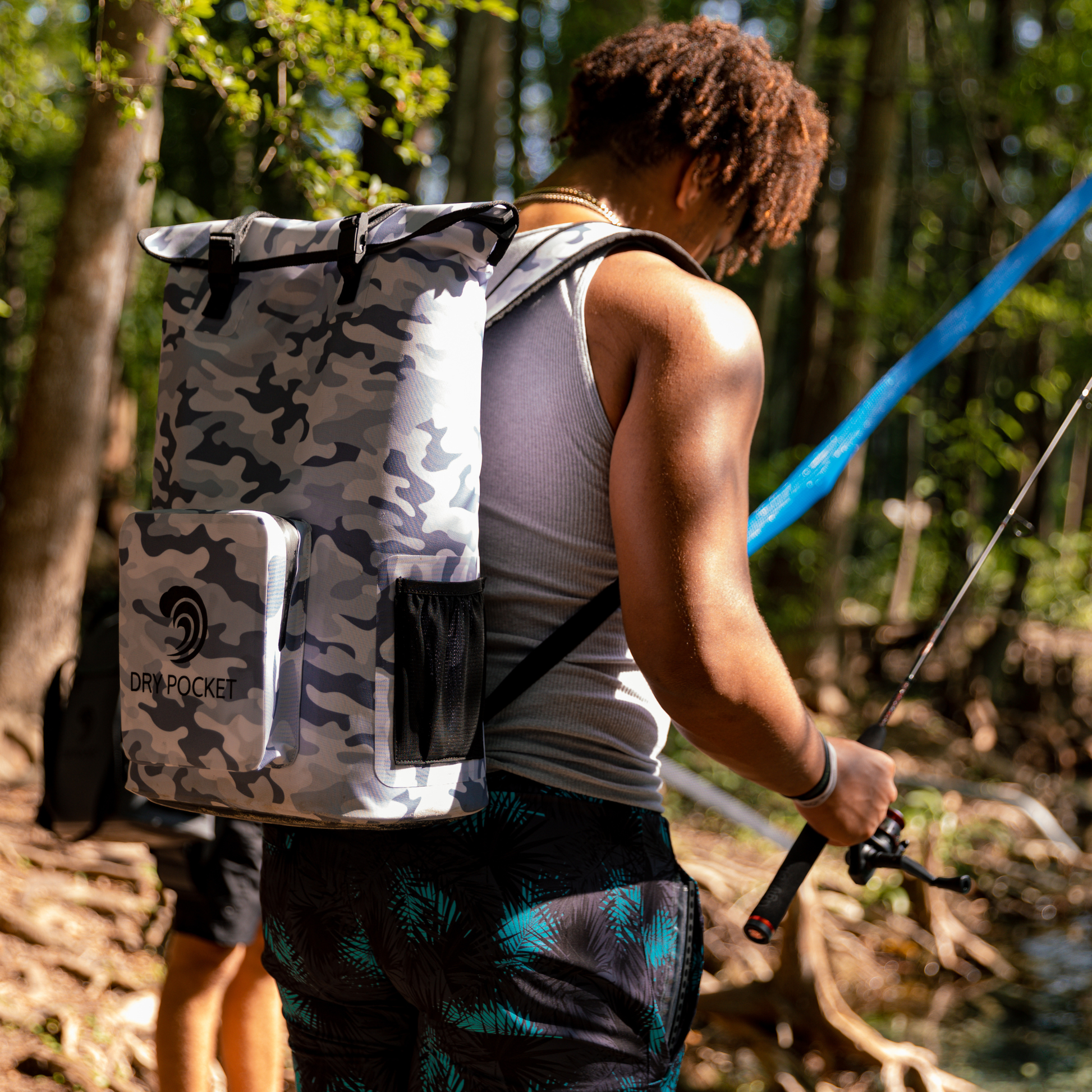Dry Pocket - Waterproof Floating Cooler Backpack Dry Bag - Snow Camo - Man fishing wearing backpack